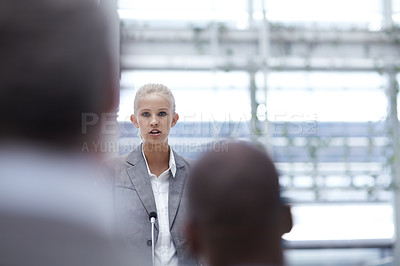 Buy stock photo A beautiful young businesswoman giving a speech to her colleagues at a conference