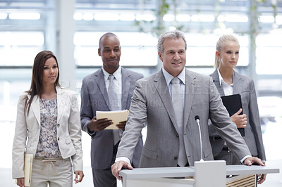Buy stock photo A senior executive commending a successful young business team at a conference