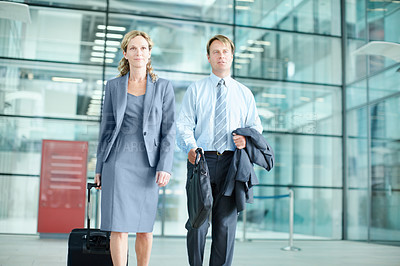 Buy stock photo Determined mature businesspeople arriving at an airport with their suitcases - Business Travel 