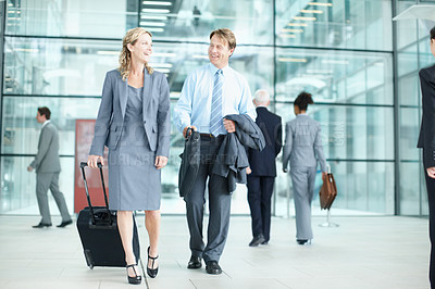 Buy stock photo Laughing mature businesspeople arriving at an airport with their suitcases - Business Travel 