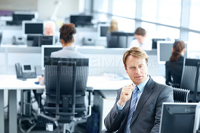 Buy stock photo Focused mature businessman sitting working on a computer in the office - portrait 