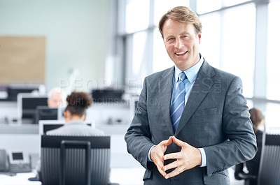 Buy stock photo Mature businessman standing in the office and smiling - portrait 