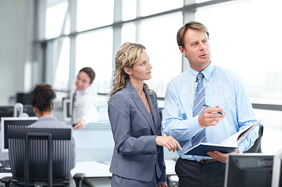 Buy stock photo Two thoughtful mature business executives discussing work in the office