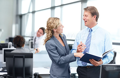 Buy stock photo Two happy mature business executives discussing work in the office