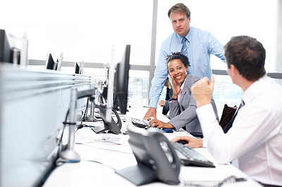 Buy stock photo Business associates sitting at their desks and working 