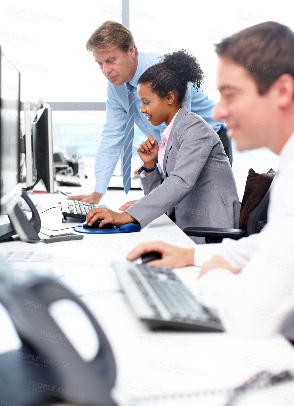 Buy stock photo Business executives sitting at their desks and working 