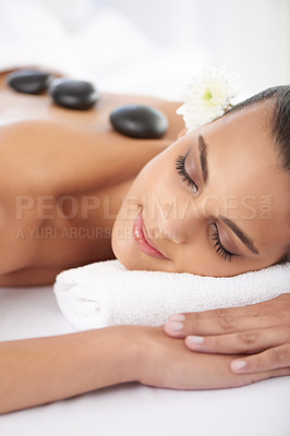 Buy stock photo Sleeping, hot stone and woman with massage at spa for wellness, health and back treatment. Self care, cosmetic and young female person relaxing for warm stone back therapy at natural beauty salon.