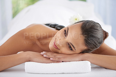Buy stock photo Woman, hot stone massage and treatment for relaxing, wellness and muscle therapy for body care. Female person, skin detox and satisfaction at resort, beauty and resting for skincare and peace or zen