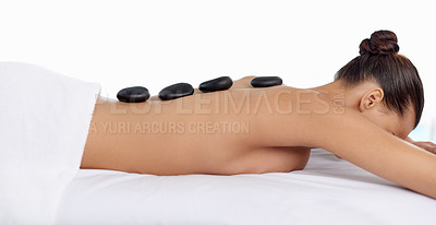 Buy stock photo Health, hot stone and woman with massage at spa for wellness, natural and back treatment. Self care, cosmetic and calm young female person sleeping for warm rock skin therapy at beauty salon.