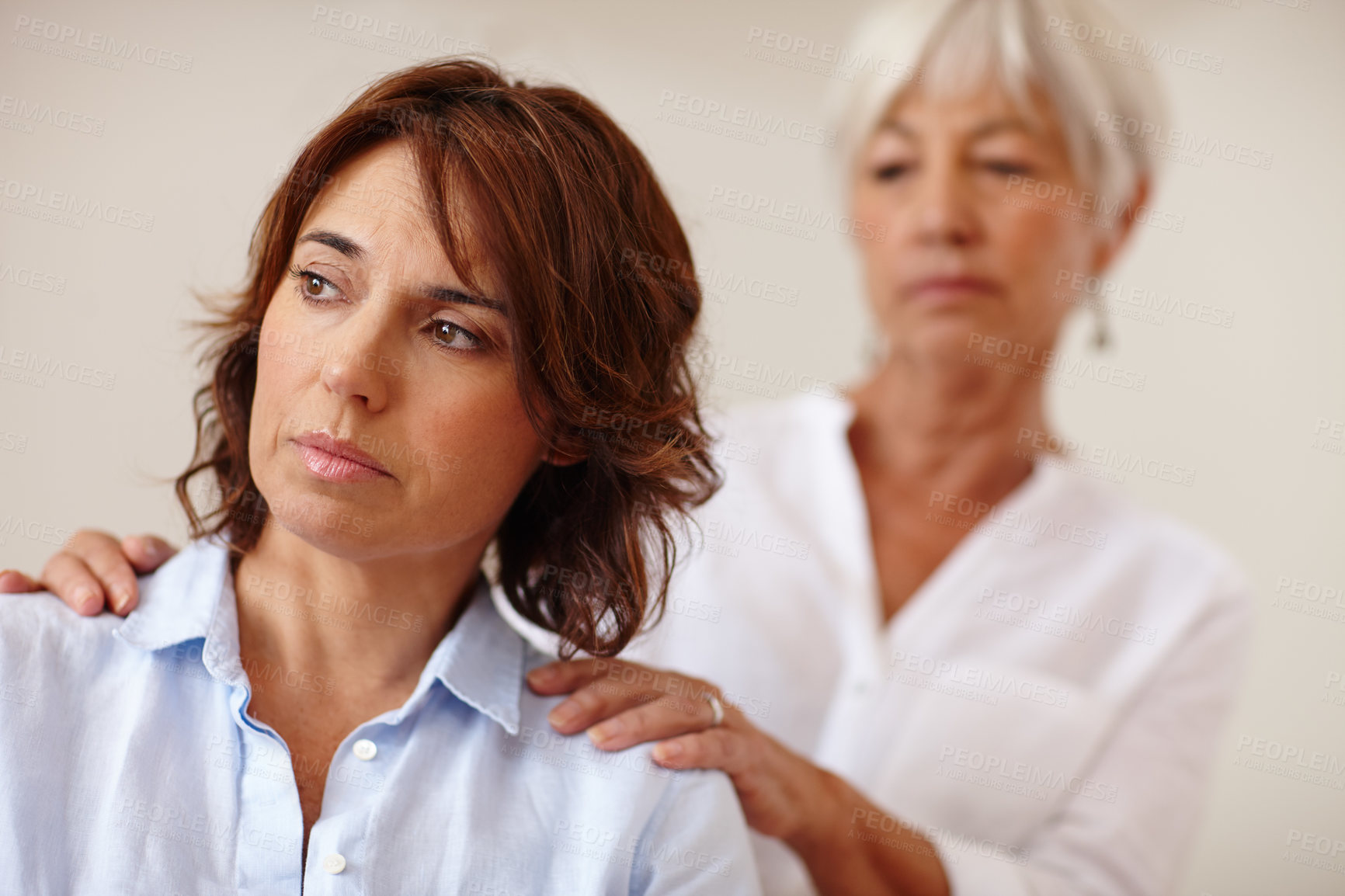 Buy stock photo Shot of a senior woman comforting her daughter who's going through a difficult time