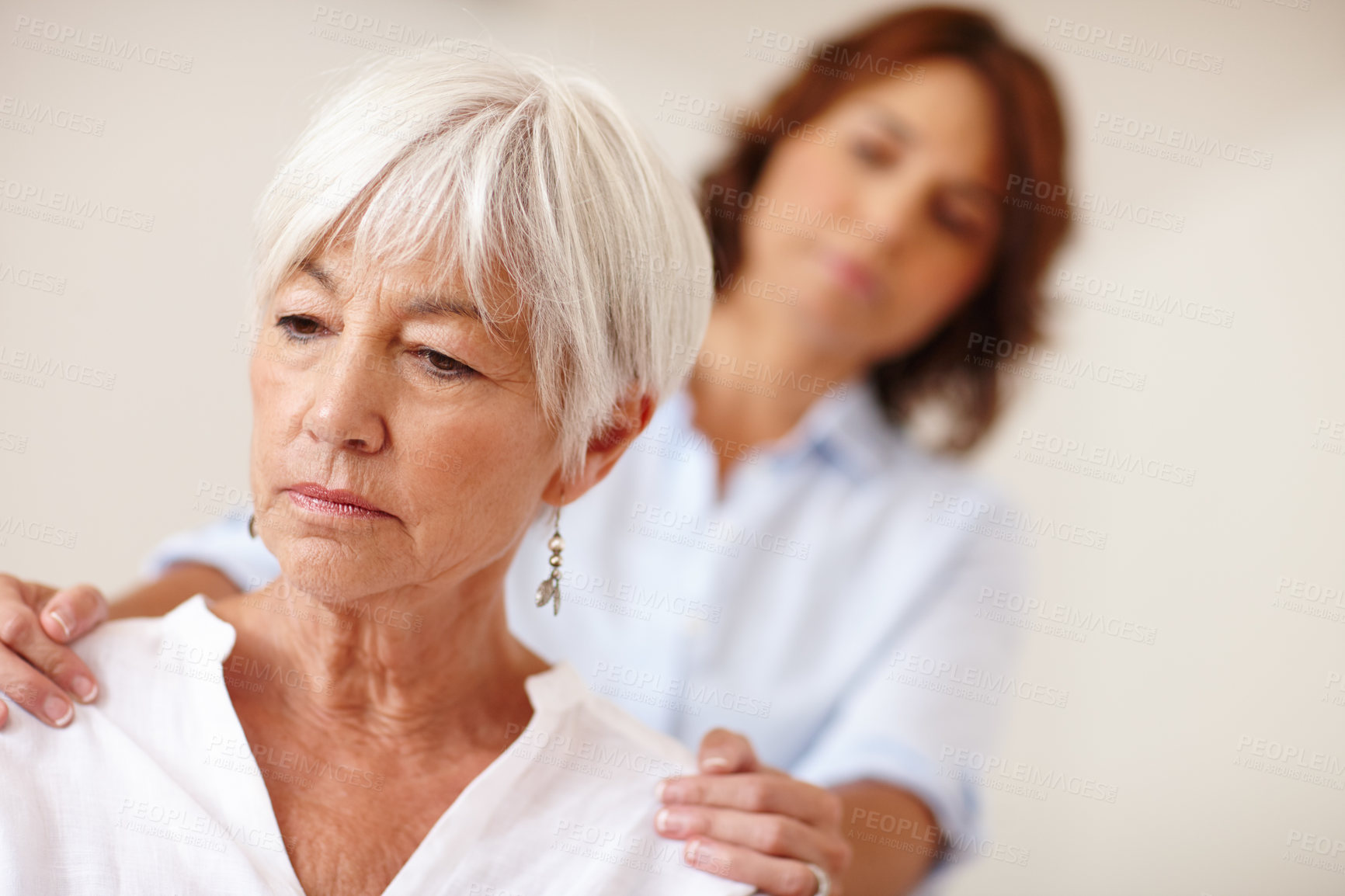 Buy stock photo Shot of a woman supporting her elderly mother through a difficult time