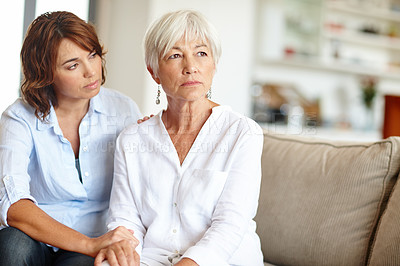 Buy stock photo Shot of a woman supporting her elderly mother through a difficult time
