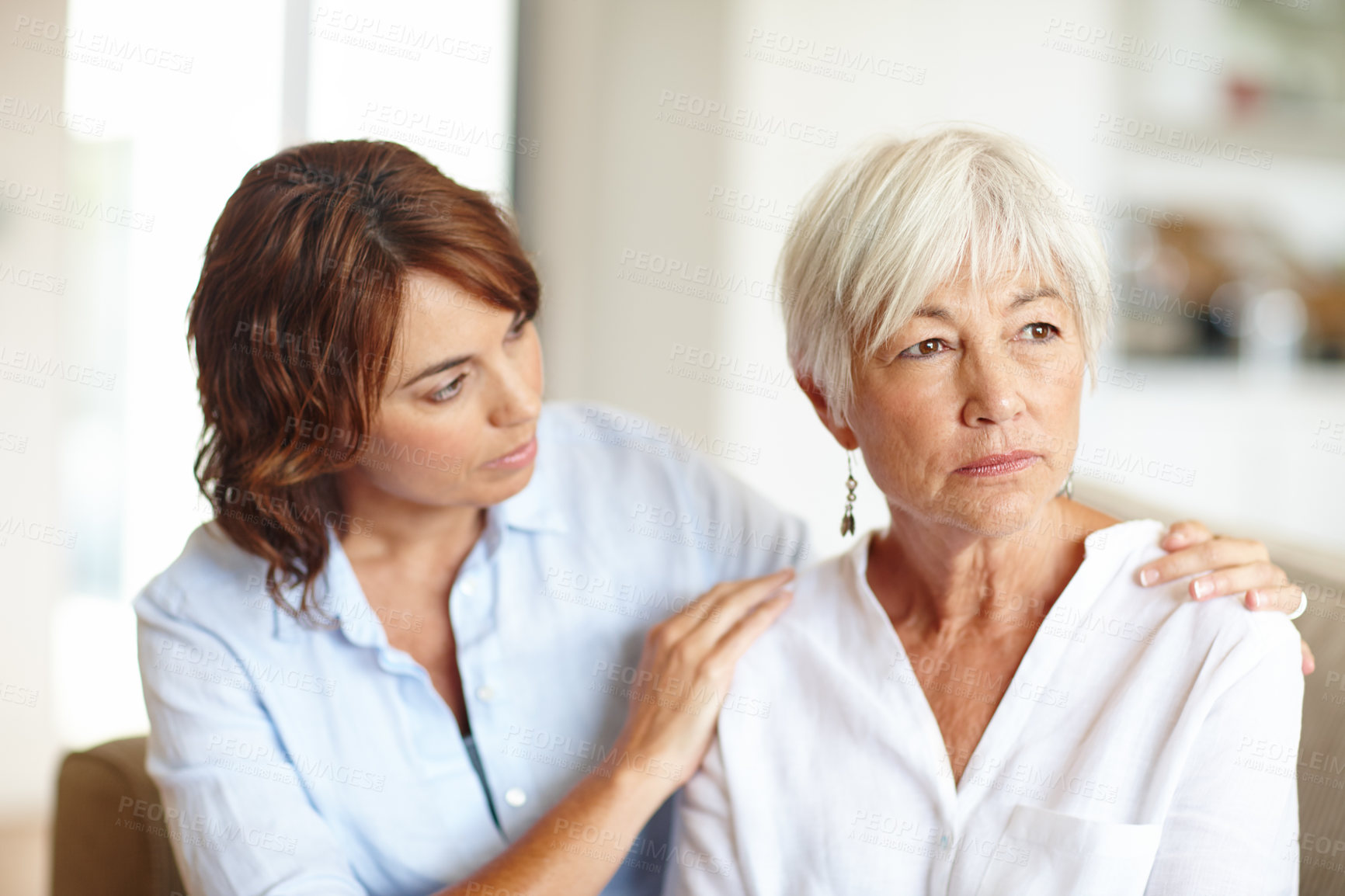 Buy stock photo Shot of a woman supporting her elderly mother through a difficult time