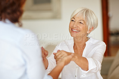 Buy stock photo Shot of a senior woman holding her daughter's hands