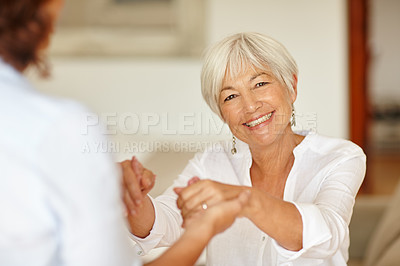 Buy stock photo Portrait of a senior woman holding her daughter's hands
