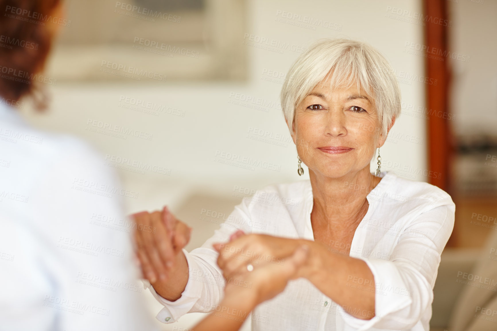 Buy stock photo Portrait of a senior woman holding her daughter's hands