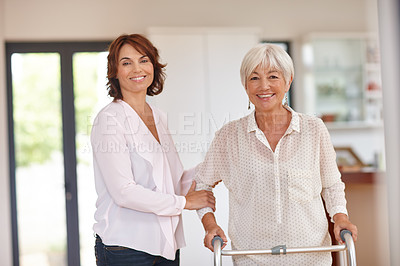 Buy stock photo Shot of a woman assisting her elderly mother with an orthopedic walker