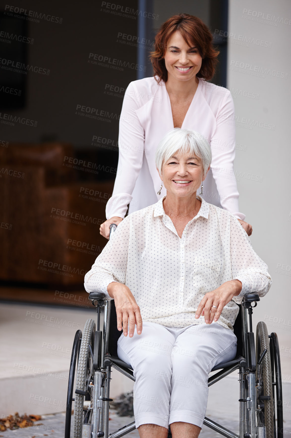 Buy stock photo Shot of a woman pushing her elderly mother in a wheelchair