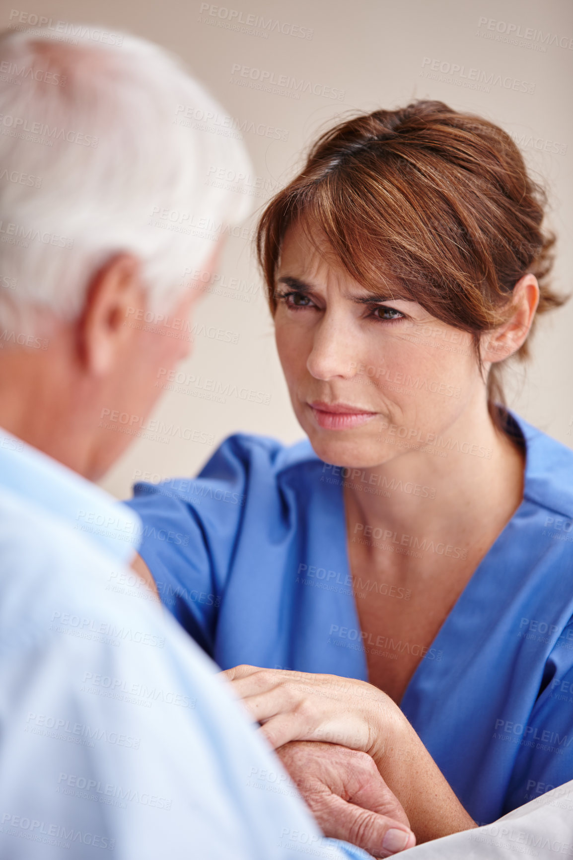 Buy stock photo Cropped shot of a female nurse checking on her senior patient