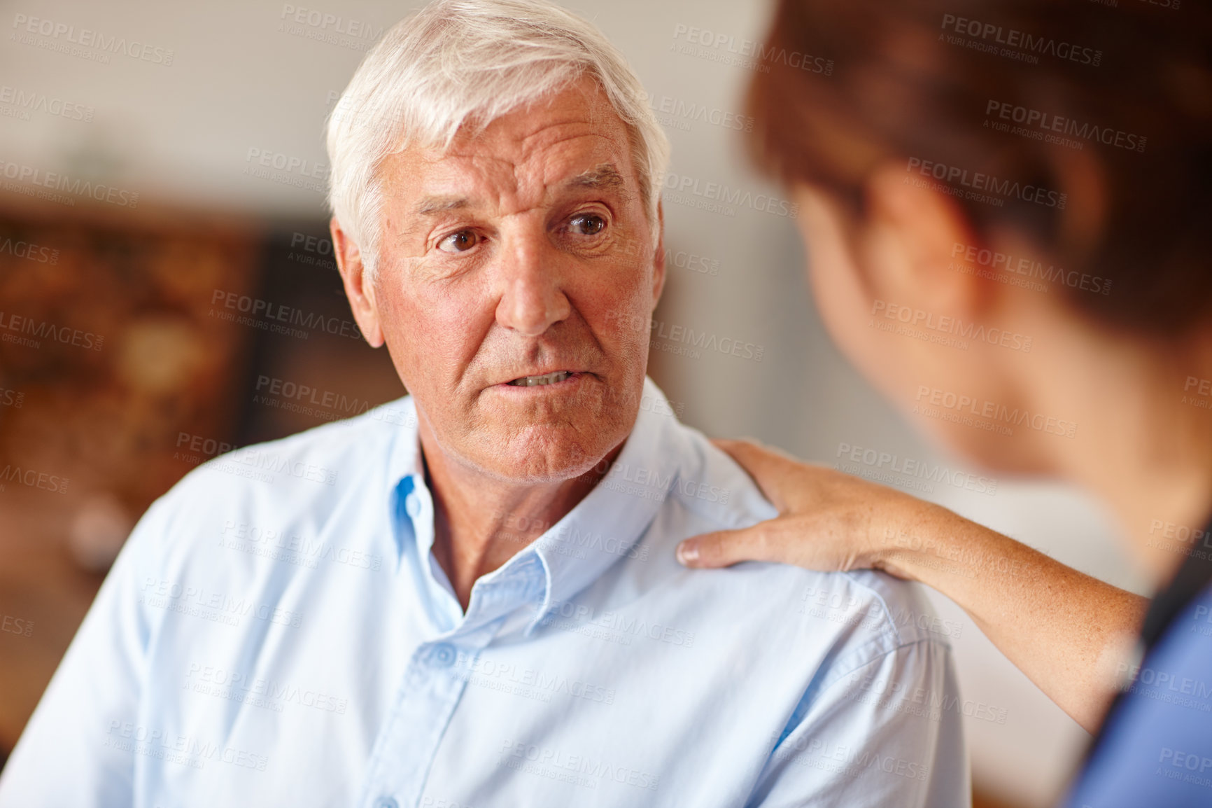 Buy stock photo Cropped shot of a female nurse checking on her senior patient