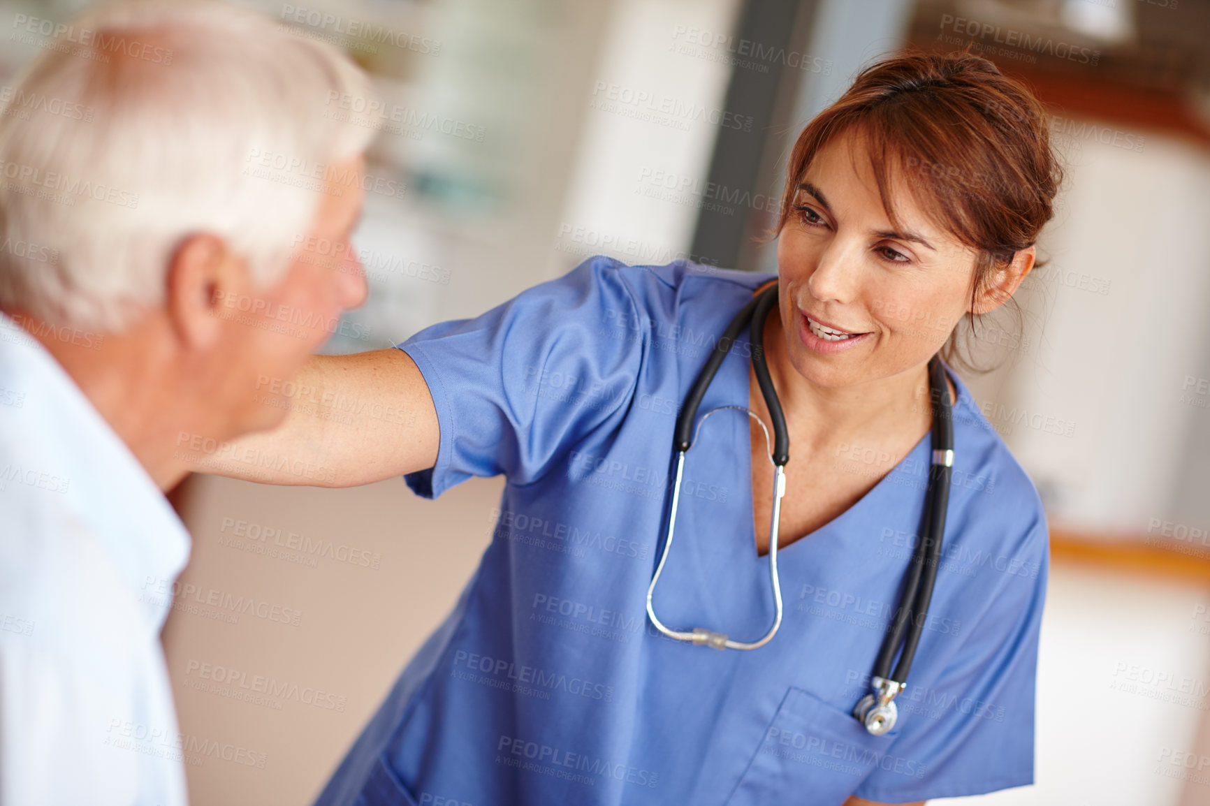 Buy stock photo Cropped shot of a female nurse checking on her senior patient