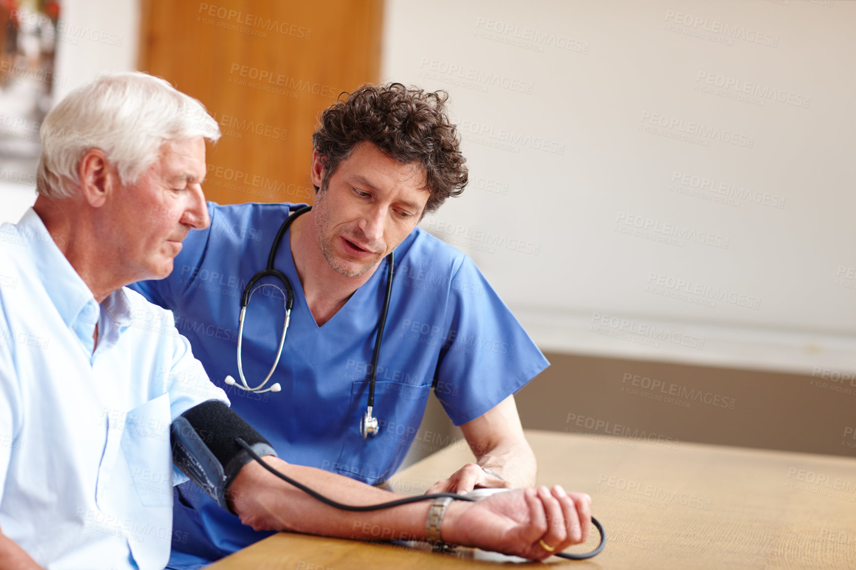 Buy stock photo Shot of a doctor checking a senior patient's blood pressure