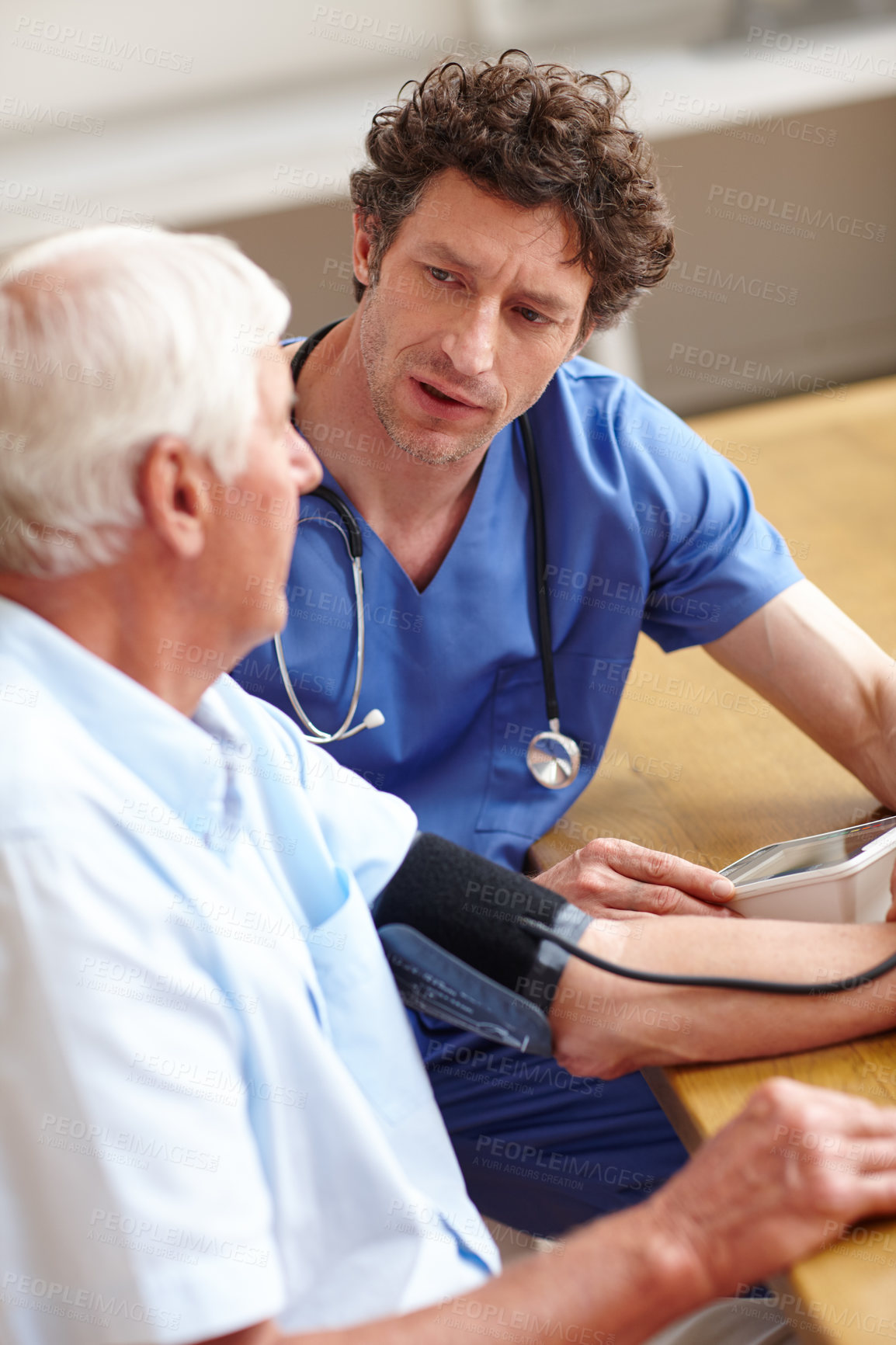 Buy stock photo Shot of a doctor checking a senior patient's blood pressure