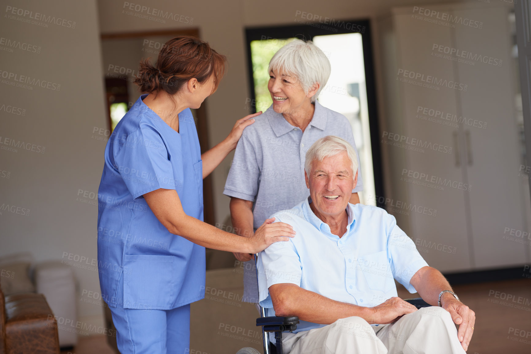 Buy stock photo Cropped shot of a nurse giving good news to her senior patient and his wife