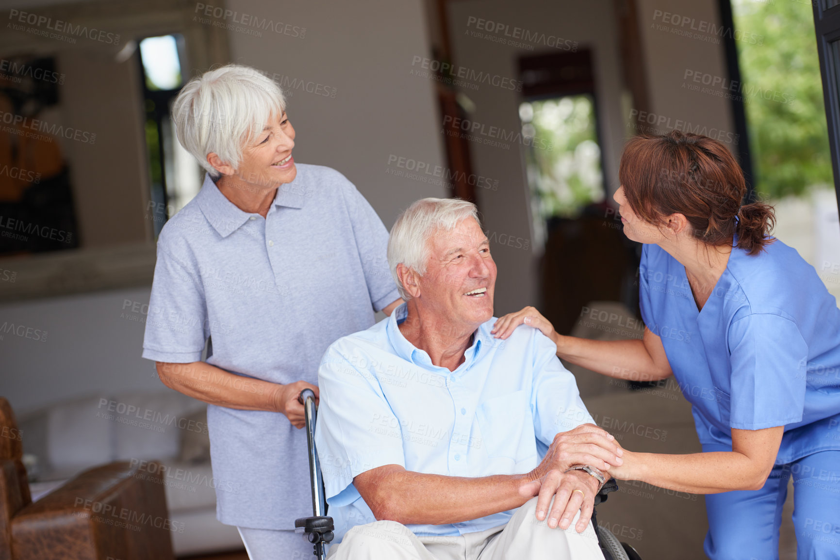 Buy stock photo Cropped shot of a nurse giving good news to her senior patient and his wife