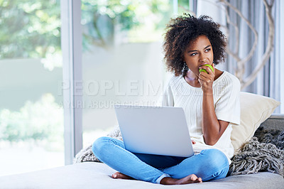 Buy stock photo Apple, laptop and thinking with black woman on sofa in living room of home to relax for wellness. Computer, fruit and problem solving with young person in apartment for contemplation or research