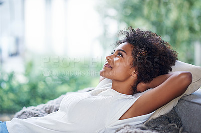 Buy stock photo Shot of young woman relaxing on the sofa at home