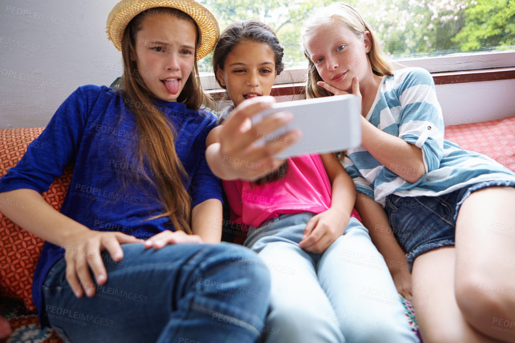 Buy stock photo Shot of a group of teenage friends taking a selfie together