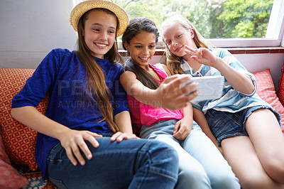 Buy stock photo Shot of a group of teenage friends taking a selfie together