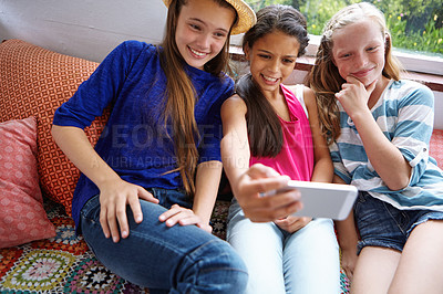 Buy stock photo Shot of a group of teenage friends taking a selfie together