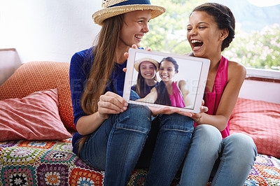 Buy stock photo Shot of teenage friends taking a selfie together on a digital tablet