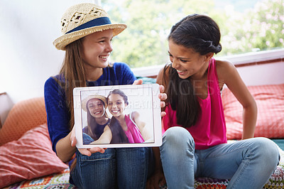 Buy stock photo Shot of teenage friends taking a selfie together on a digital tablet