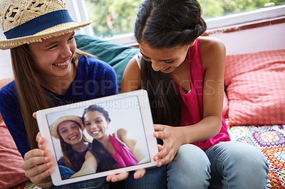 Buy stock photo Shot of teenage friends taking a selfie together on a digital tablet