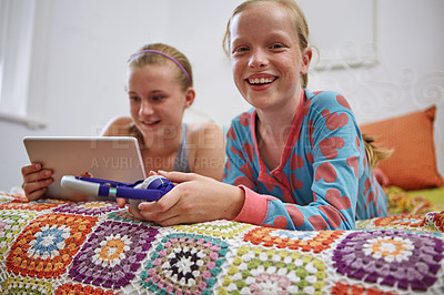 Buy stock photo Shot of two teenage friends using a digital tablet together at home