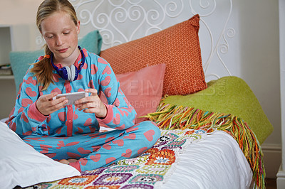 Buy stock photo Shot of a teenage girl texting in her bedroom