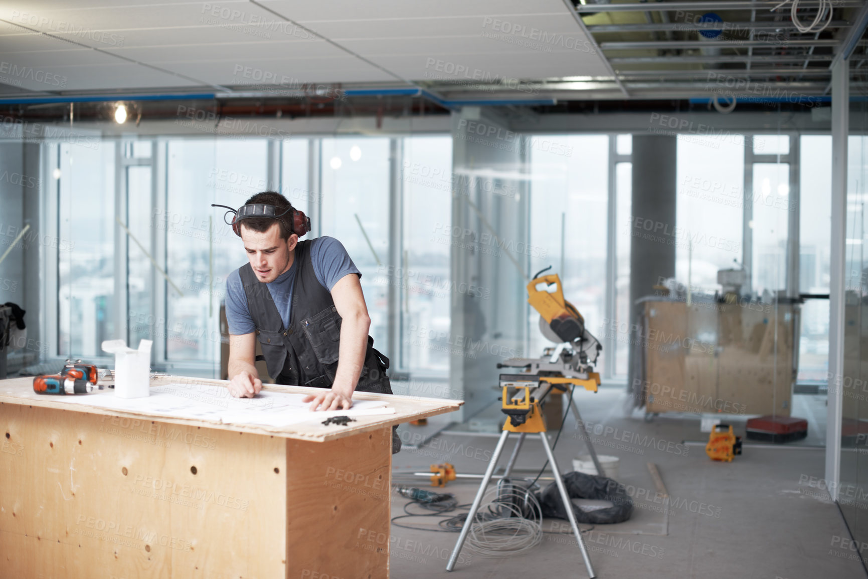 Buy stock photo Man, blueprint and carpenter with construction site, renovation and drawing for urban infrastructure. Floor plan, paperwork and illustration for engineering, property development and maintenance