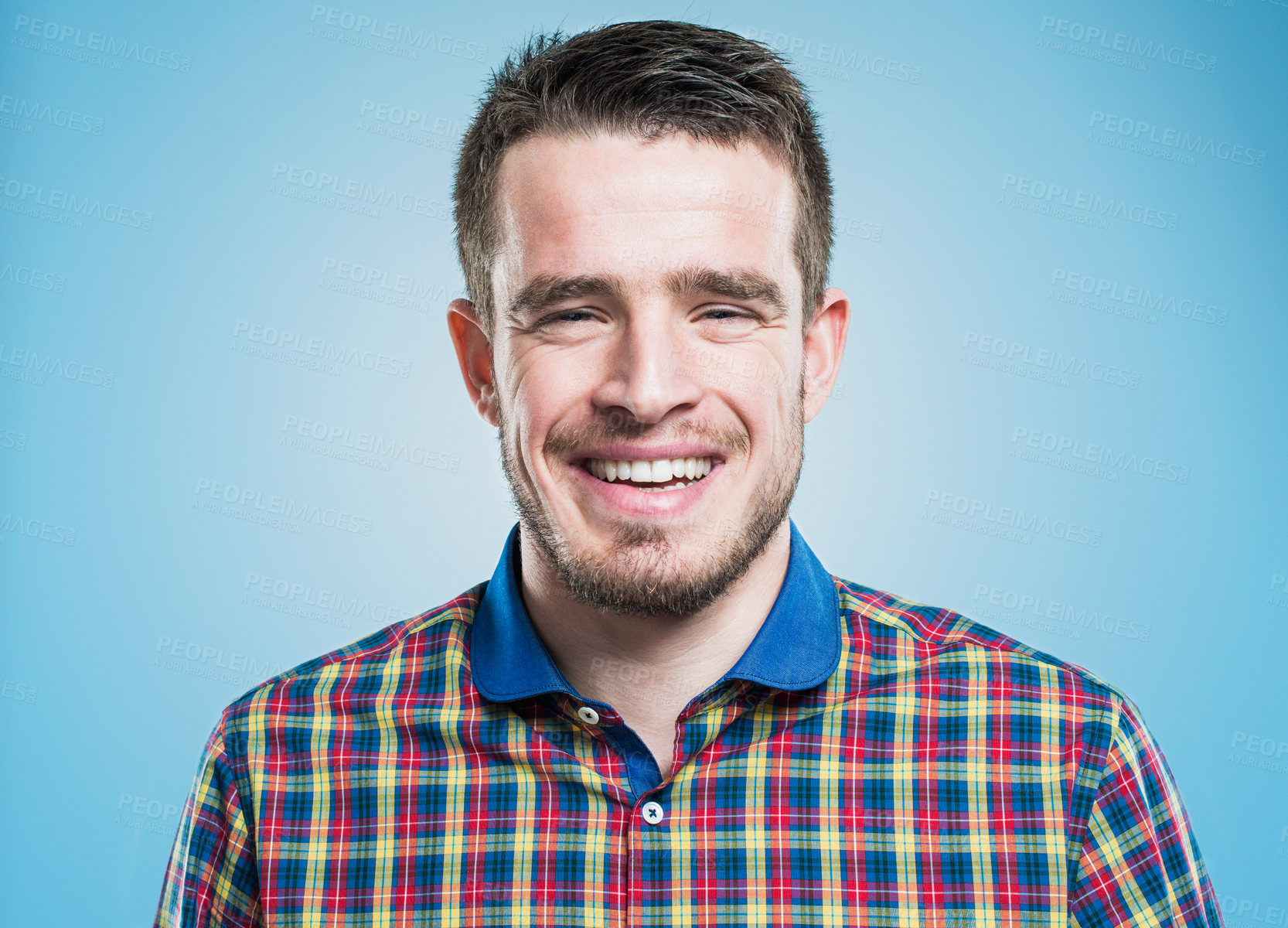 Buy stock photo Happy man, portrait and laughing with studio for funny joke, expression or creative model on a blue background. Male person, beard and shirt with smile in joy for fashion, style or positive attitude