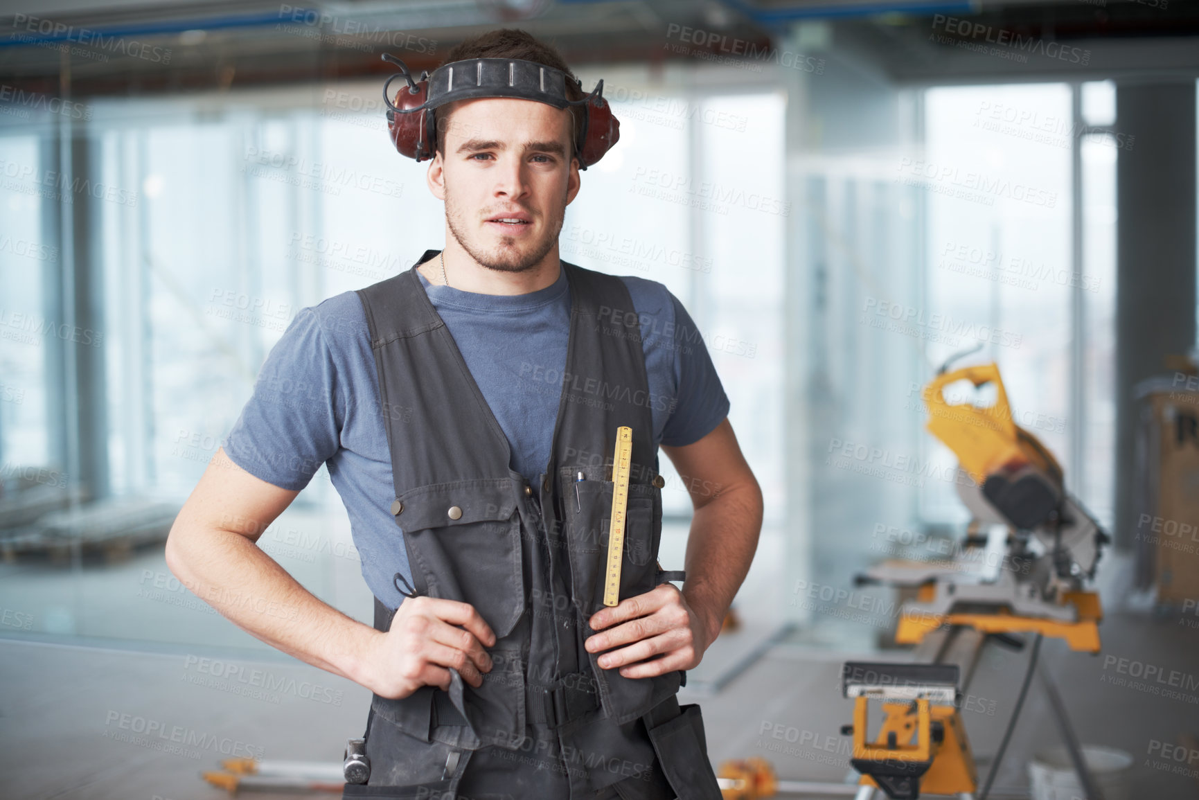 Buy stock photo Handsome young contractor standing on a construction site