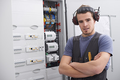 Buy stock photo Portrait, electrical engineer and man with arms crossed, control room and confident for power generation. Maintenance, contractor and person with noise cancelling headphones, cables and installation