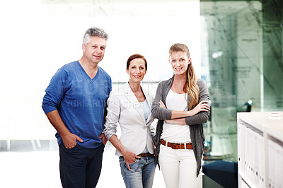 Buy stock photo A group of three casual businesspeople standing next to each other in a row