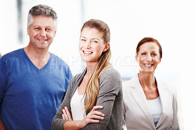 Buy stock photo Three casual businesspeople standing next to each other and smiling