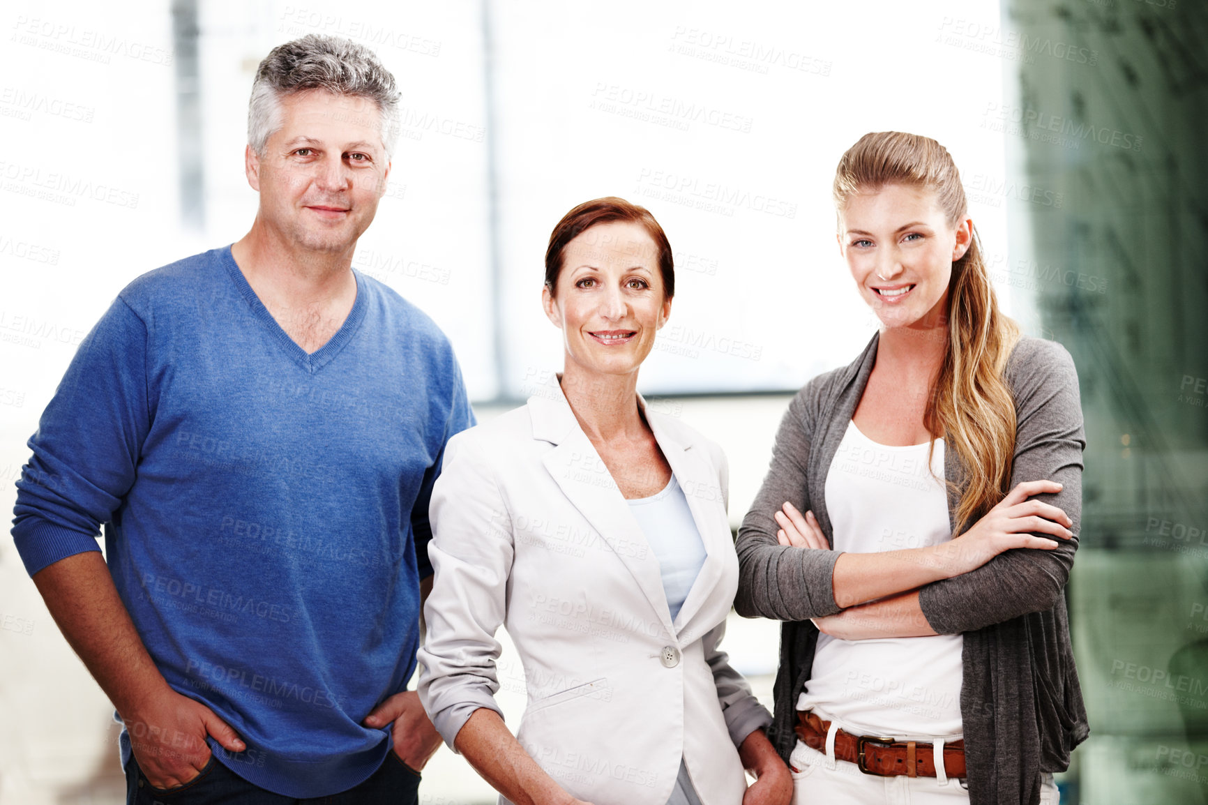 Buy stock photo Portrait of three casual office workers standing next to each other and smiling at the camera