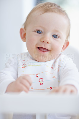 Buy stock photo A cute baby boy smiling while sitting in his high chair