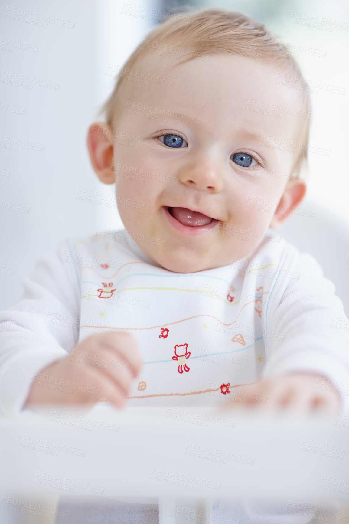 Buy stock photo A cute baby boy smiling while sitting in his high chair