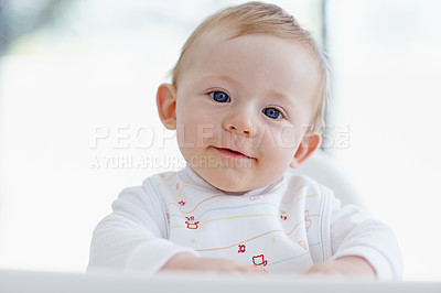 Buy stock photo A smiling baby boy sitting in his high chair