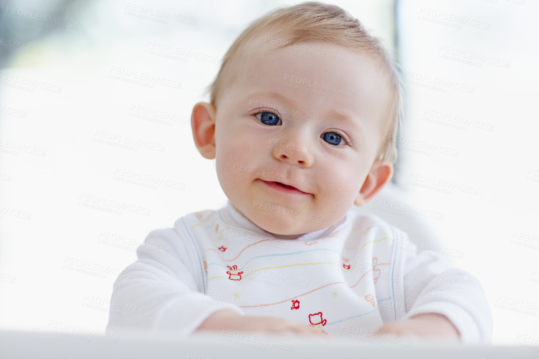 Buy stock photo A smiling baby boy sitting in his high chair